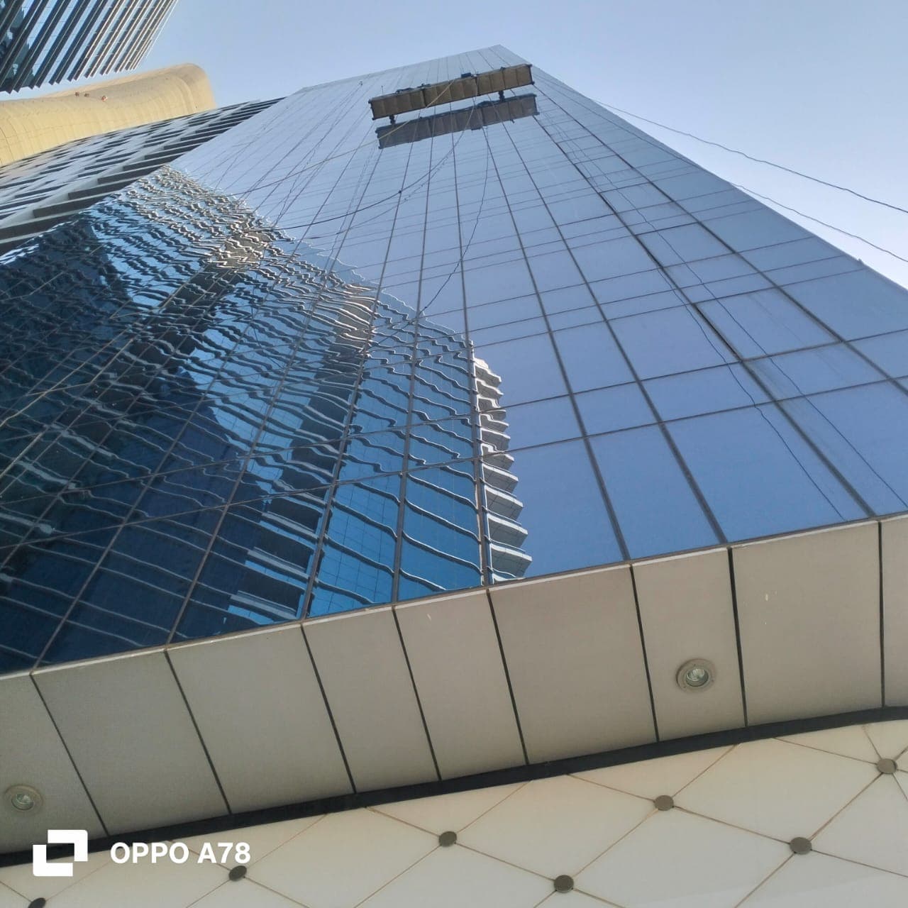Suspended access platform on a glass high-rise facade in Abu Dhabi