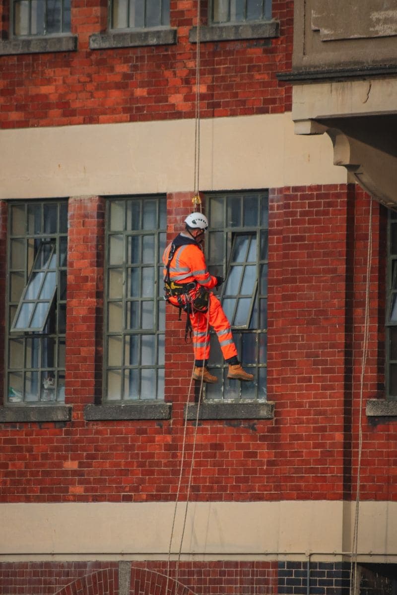 Operative working at height in a safety harness
