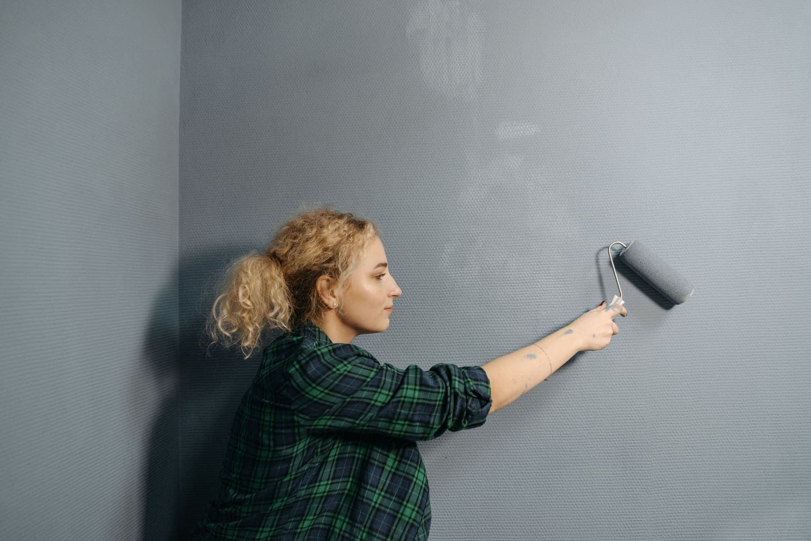 Professional painter applying finish to an interior wall