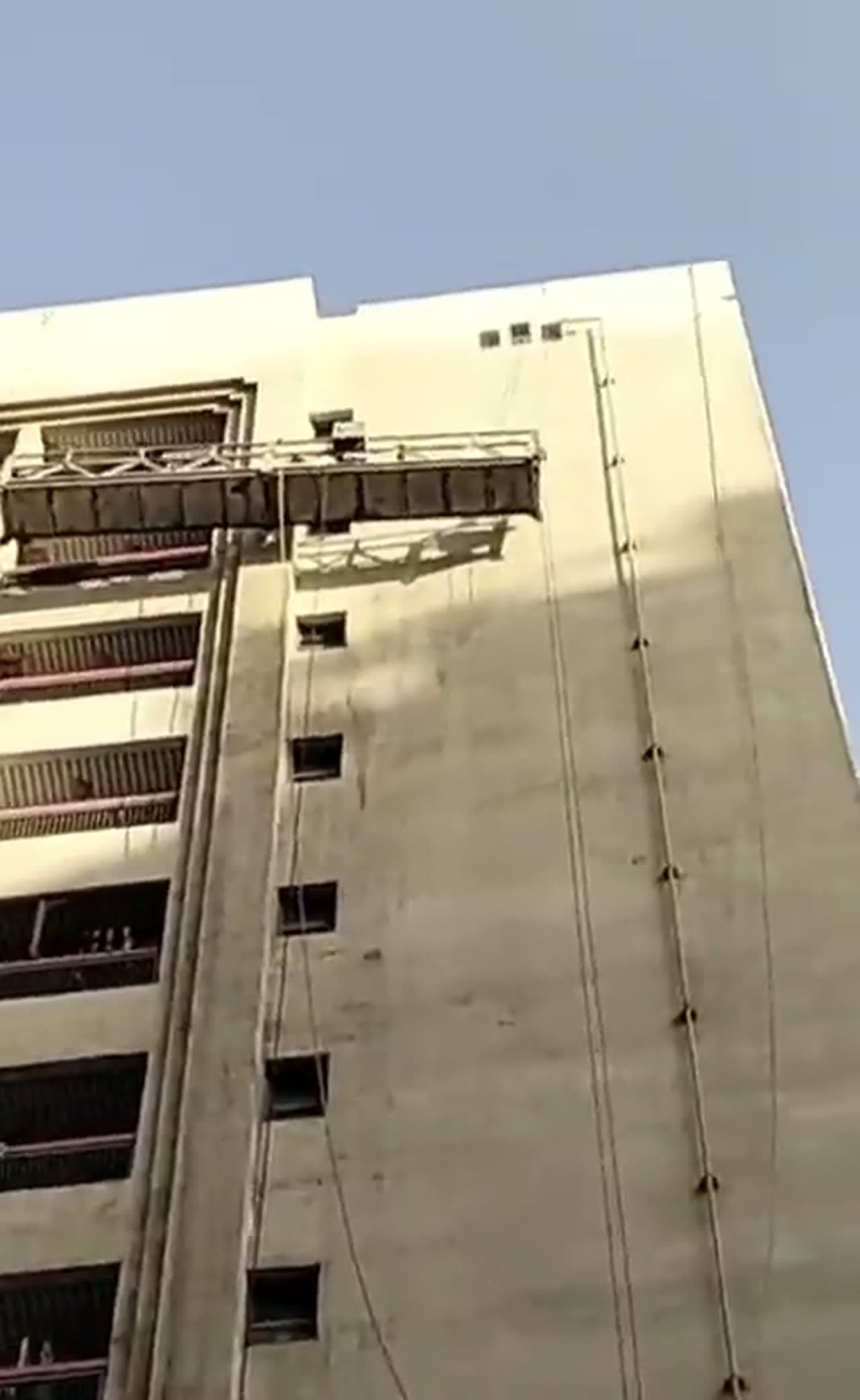 Masters Facilities Management suspended platform descending a high-rise facade in Abu Dhabi